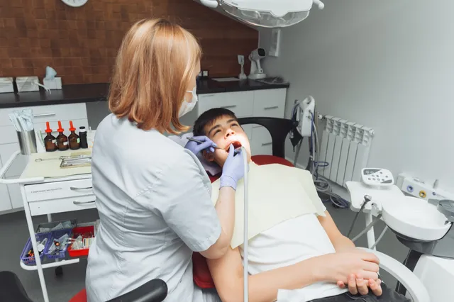 A dentist treating a patient in a dental clinic