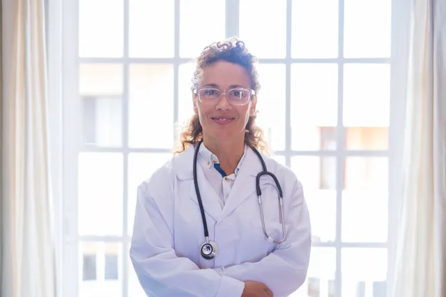 A physician in a white coat with a stethoscope